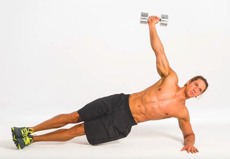 Man performing a dumbbell side plank exercise