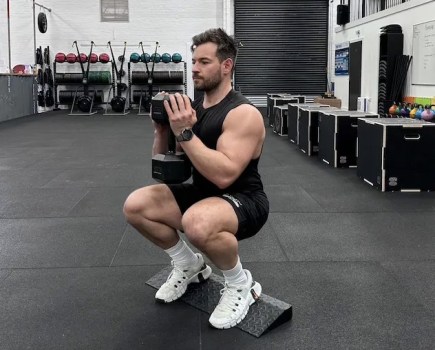 Man performing a dumbbell leg workout