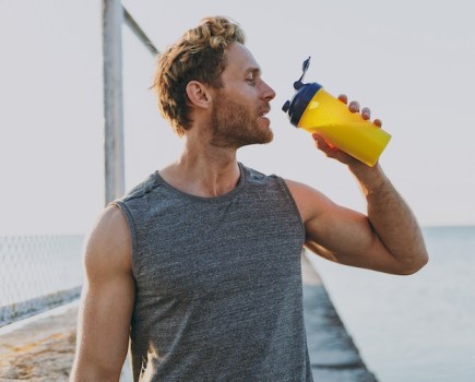 Close-up of a man drinking a sports drink