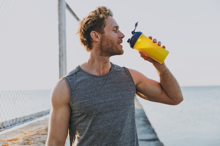 Close-up of a man drinking a sports drink