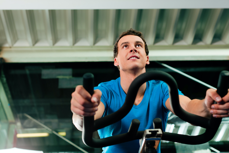 Close-up of the upper torso of a man riding an exercise bike