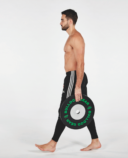 Man performing a single-arm farmer's walk with a weight plate