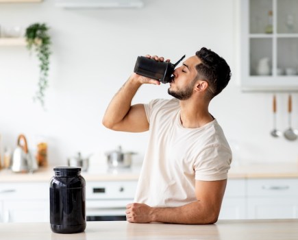 Young man drinking a pre-workout shake