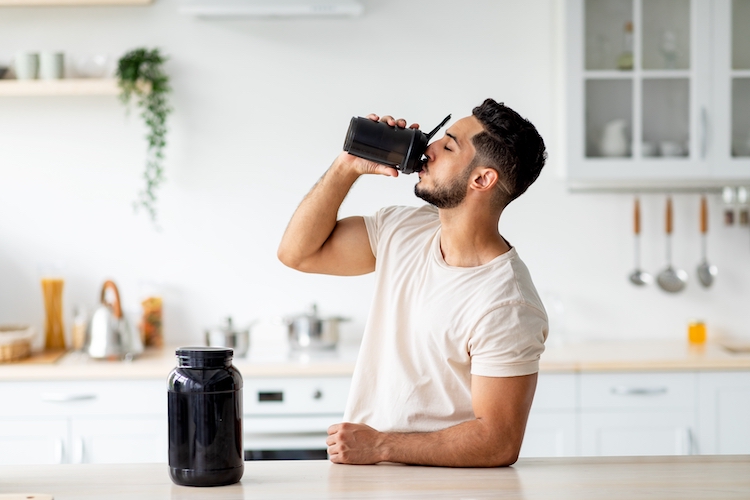 Young man drinking a pre-workout shake