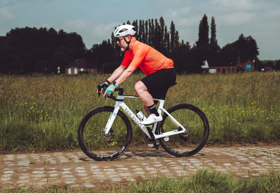 Man cycling on cobbles on a road bike