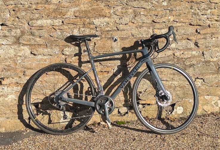 Road bike leaning against a stone wall