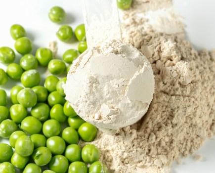 Scoop of protein powder and peas