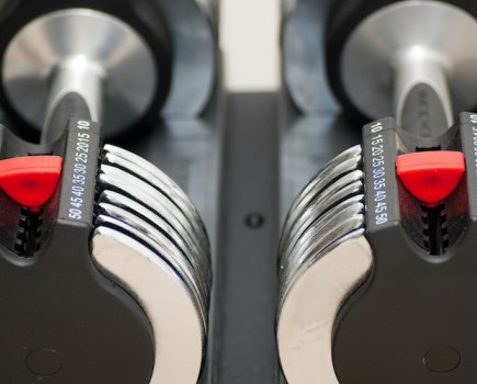 Close-up of adjusting mechanisms on adjustable dumbbells