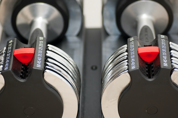 Close-up of adjusting mechanisms on adjustable dumbbells