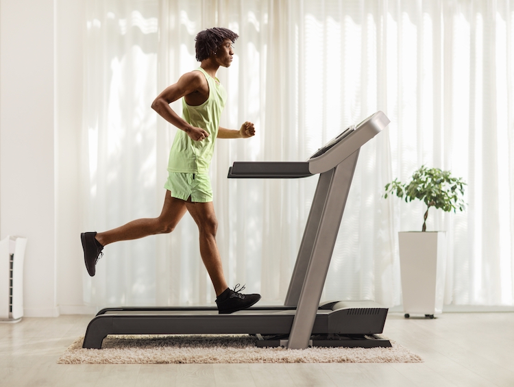 Man exercising at home on a treadmill