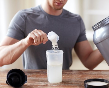 A man mixing a clear protein drink