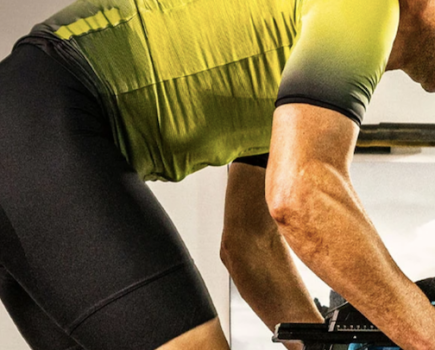 Close-up of a man riding an exercise bike