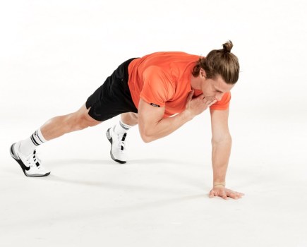 Man performing one-handed push-up