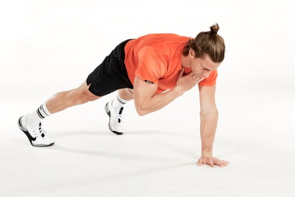 Man performing one-handed push-up