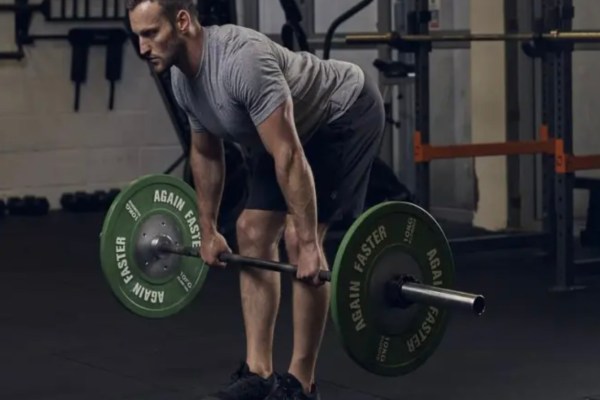 Man exercising in the gym with a barbell