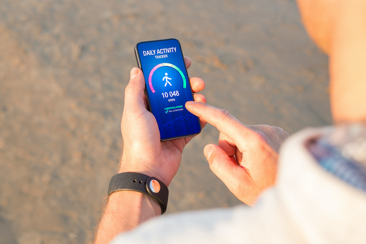 A man looking at a workout app on his mobile