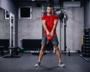 Man in a gym working out with a kettlebell