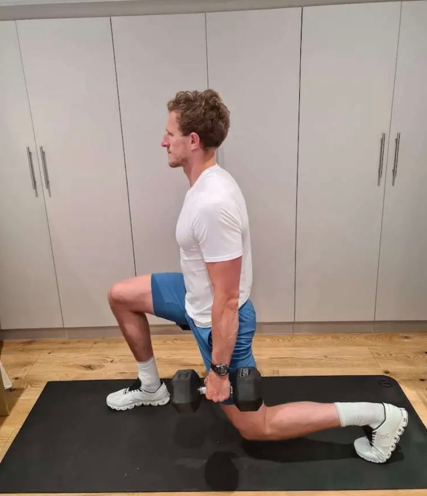 Man performing a dumbbell lunge