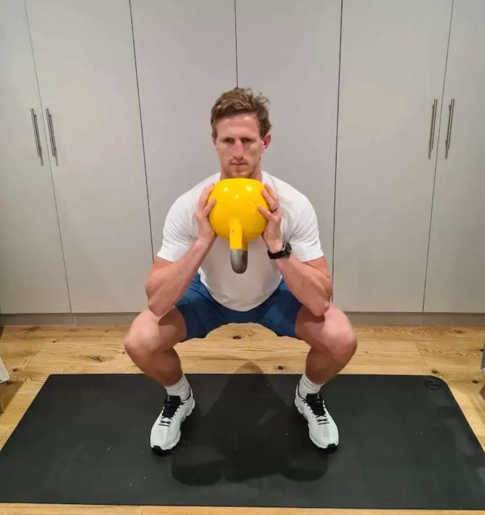 Man performing a kettlebell squat