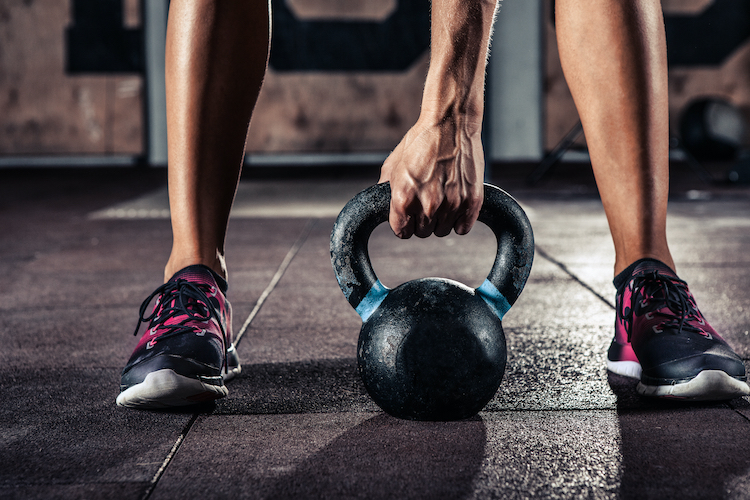 Close-up of a man holding a kettlebell