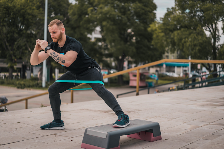 Man working out with resistance bands outside