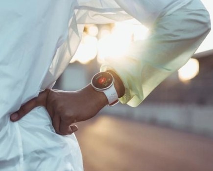 Product shot of a runner wearing a fitness watch