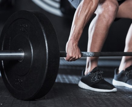 Close-up of man lifting dumbbell
