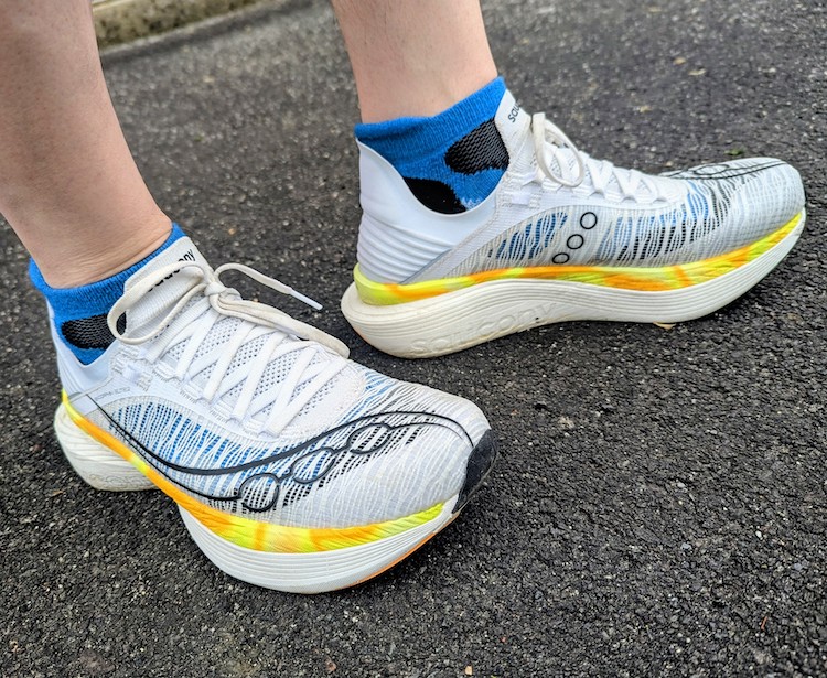 Close-up of a man's feet wearing Saucony running shoes