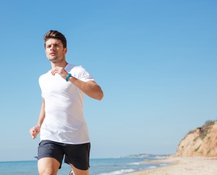 Young man running along a beach