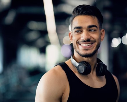 Man in a gym wearing headphones