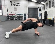 Man performing a sideways dumbbell exercise