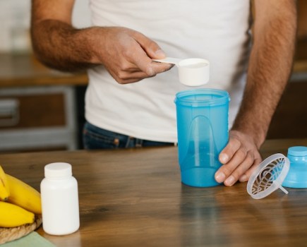 Close-up of a man making a pre-workout drink