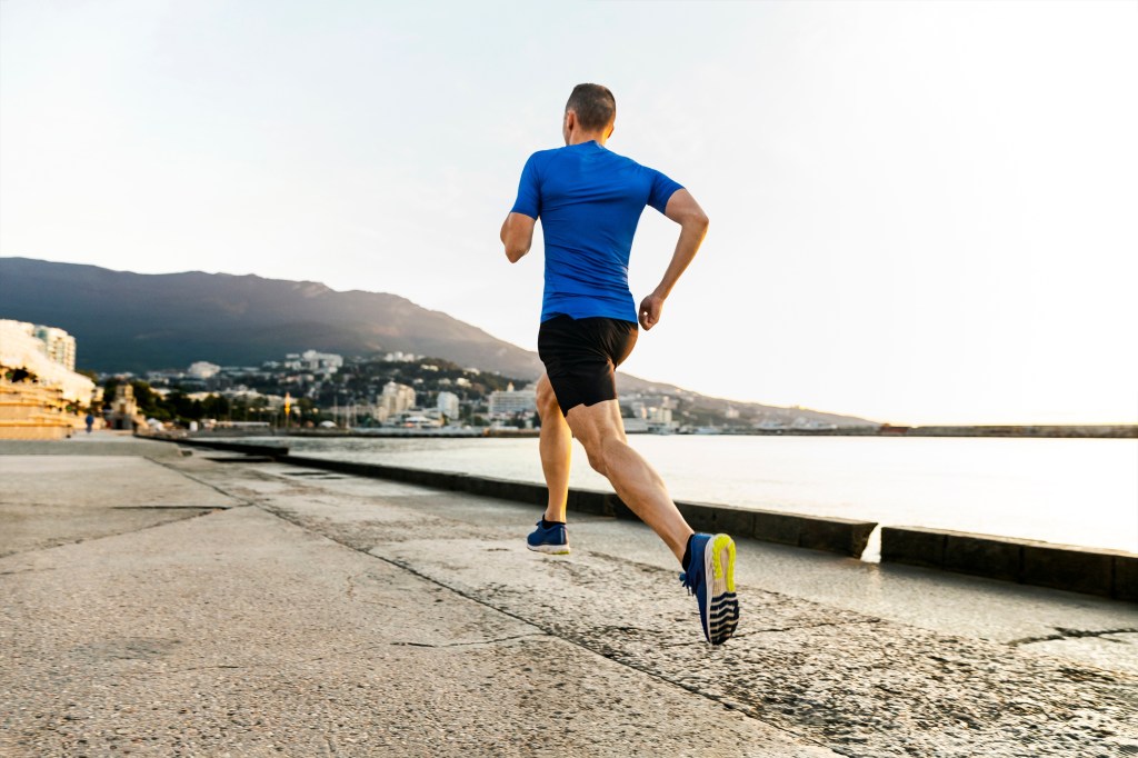 Male,Runner,Athlete,Running,On,Sea,Embankment