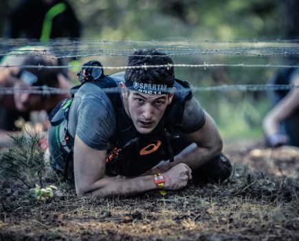 man takes on the spartan race as one of the best fitness challenges to do in 2026