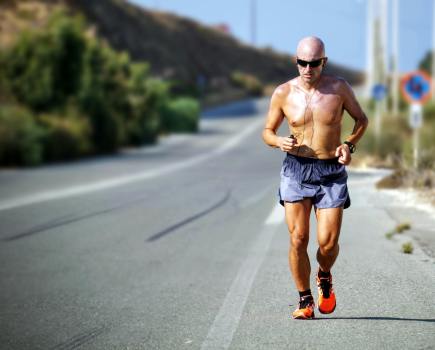 man runs along road in best running shorts reviewed