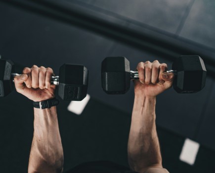 best adjustable dumbbells lifted into the air