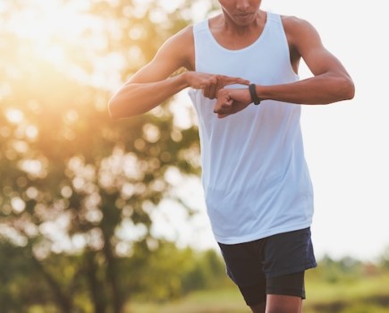 Close-up of runner checking his watch