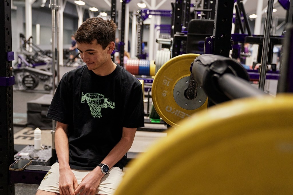 Triathlete Alex Yee relaxing mid-workout