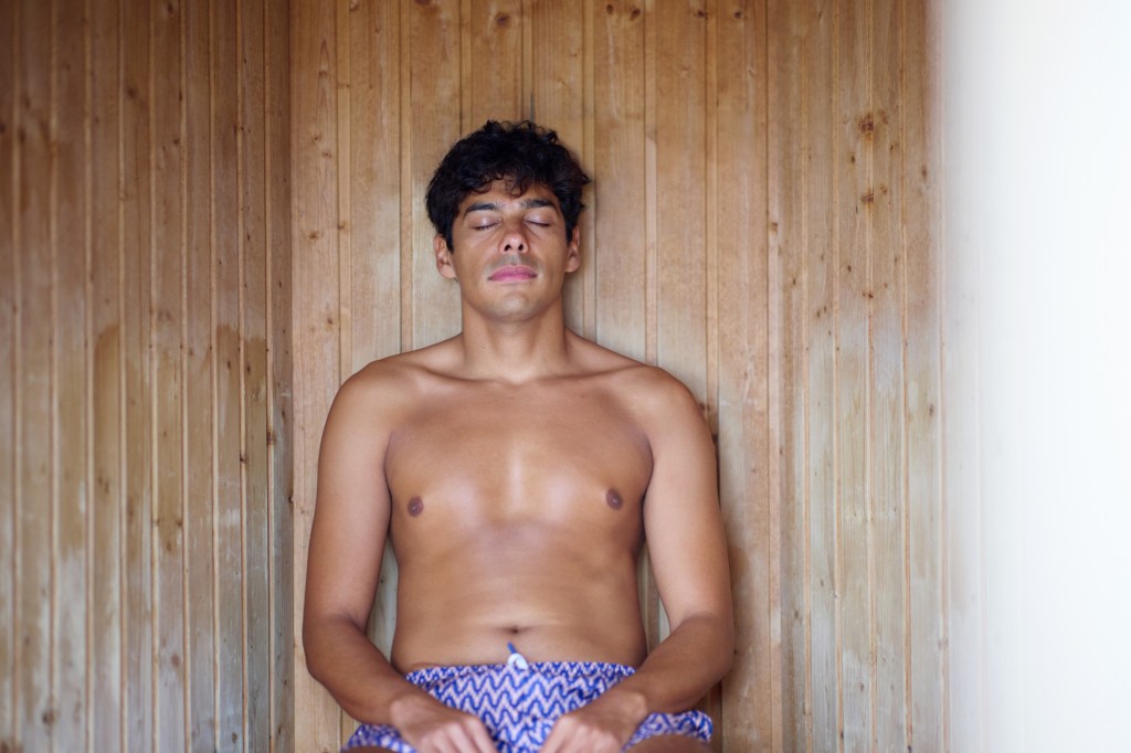 Man relaxing in beach sauna