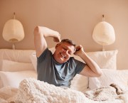 Middle-aged man waking up in the morning happy