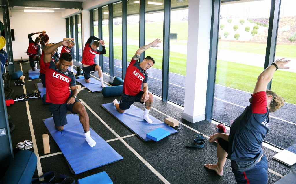 Swansea City footballers being put through their Pilates paces